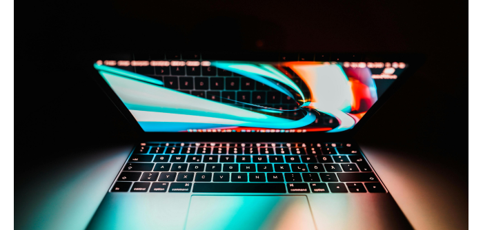 Laptop displaying colorful graphics, representing data visualization and technology